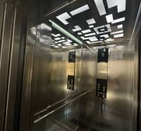 Interior of an elevator with modern lighting and mirrors in a Recreational Apartment.