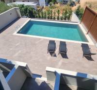 A holiday apartment in Ksamil with a pool and sun loungers on the sun terrace.