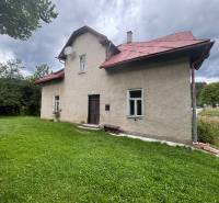 A family house in Makov on Centrum Street, with a garden and trees in the background.