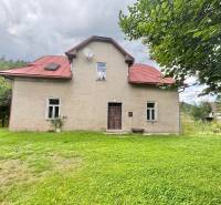 Family house in the center, Makov, surrounded by a grassy plot with trees.