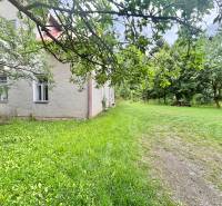 A family house in Makov on Centrum Street surrounded by a garden and trees.