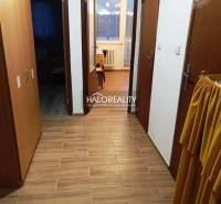 A hallway and a 2-room apartment with ceramic tiles, wooden doors, and access to the rooms.