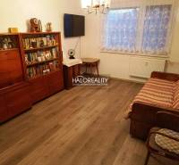 A nice living space with a sofa and a bookshelf in a 2-room apartment, wooden floor.