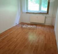 A room with a light laminate floor and a window in a 3-room apartment.