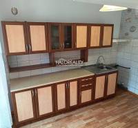 A kitchen in a 3-room apartment with cabinets, a countertop, and a sink.