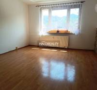 A spacious room with wooden flooring and a large window in a 3-room apartment.
