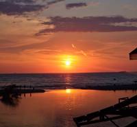 Sunset over Sarandë with reflection on the water surface at the Recreational Apartment.