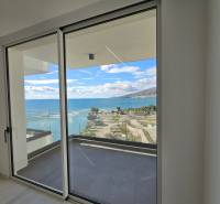 View from a holiday apartment in Sarandë to the coast and blue sky.