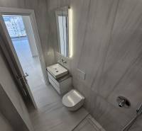 Bathroom of the holiday apartment with a sink, shower, and tasteful lighting.