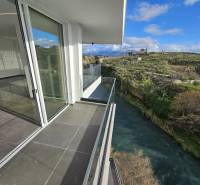 The balcony of a holiday apartment in Sarandë with a view of the river and the countryside in the background.
