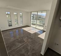 Spacious living room with large windows and a balcony in the Holiday Apartment.