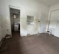The interior of the building with damaged walls and tiles, suitable for renovation.