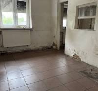 Empty commercial space with a window and a radiator.
