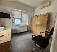 Office with a desk and chair, storage cabinets, and a television.