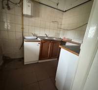 A small kitchenette with a gas boiler in commercial premises.