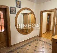 Hallway with a mirror and wooden doors in a 3-room apartment.