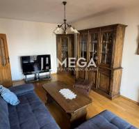 Living room with wooden furniture and a sofa in a 3-room apartment.