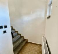 An interior with stone stairs and a radiator in a 2-room apartment.