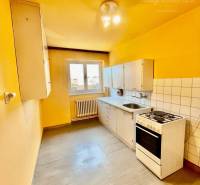 A kitchen with a gas stove and storage spaces in a 2-room apartment.