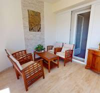 A seating area with wooden furniture in a family house, creating a cozy atmosphere.