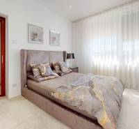 Bright bedroom with a large bed and decorative pillows in a family house.