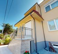A family house in Komárno with a terrace, garden, and modern architectural features.