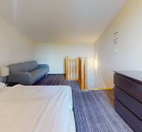 Bedroom in a 2-room apartment with a bed, sofa, and dresser.