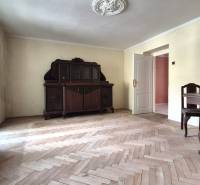 A room in a 3-room apartment with wooden furniture and parquet flooring.