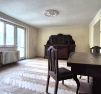 A room with wooden furniture and parquet floors in a 3-room apartment.