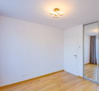 A room with a wooden floor and a built-in wardrobe in a 3-room apartment.