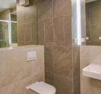 Bathroom with a wall-hung toilet and a shower in a 3-room apartment.