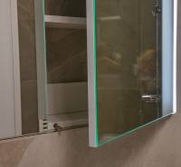 A bathroom with a mirror and an open cabinet in a 3-room apartment.