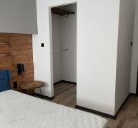 Bedroom interior with a bed and built-in wardrobe in a 3-room apartment.