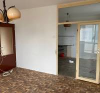 Interior of a 3-room apartment with parquet flooring and glass doors.