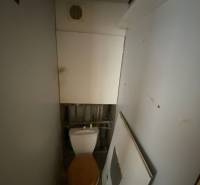 A small bathroom with a toilet and ventilation in a 3-room apartment.