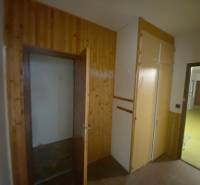 A hallway with wooden paneling and a built-in wardrobe in a 3-room apartment.