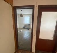A room in a 3-room apartment with a bare floor and a window.