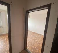 Hallway in a 3-room apartment, parquet floors, entrance to two rooms, window with a view.