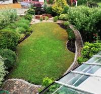 The garden of the family house on J.Š.Šikuru in Martin with a well-maintained lawn and ornamental shrubs.