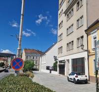 Konventná Street in Bratislava - Old Town, commercial spaces and traffic sign.