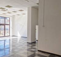 Spacious commercial spaces with large windows and tiled floors.