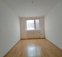 A room in a 3-room apartment with a wooden decor floor and white walls.