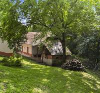 A family house on Dzurákovec in Brezová pod Bradlom surrounded by greenery and trees.