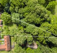 Aerial view of the land and buildings, surrounded by forest in Brezová pod Bradlom, Dzurákovci street.