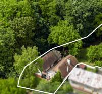 Aerial view of a family house in Brezová pod Bradlom on Dzurákovci Street, surrounded by forest.