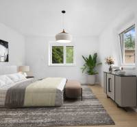 Bedroom in a family house with a bed, dresser, and plant on a light carpet.
