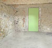 Stone walls with exposed bricks and doors in a family house.
