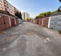 Garages on Považská Street in Košice, the Západ district, are lined by panel buildings.