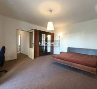 1-bedroom apartment with a spacious bed and wardrobe, rear entrance available.