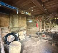 Workshop in a family house with wooden furniture and tools on the walls.